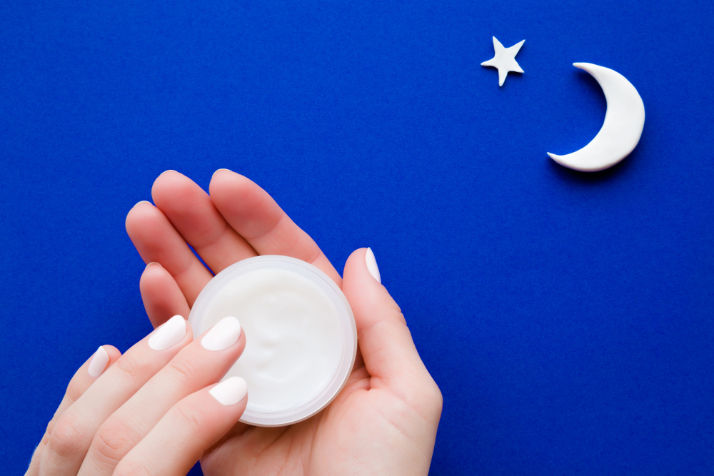 Young,,perfect,woman,hands,holding,white,jar,and,using,moisturizing